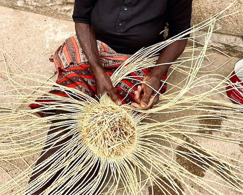 woman weaving a basket